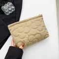 Beige floral quilted puff storage bag with elegant textured finish and gold zipper - Khaki