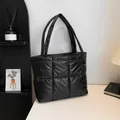 Minimalist black quilted puffer tote bag for women with glossy finish and large capacity - Black