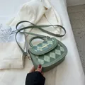 Elegant sage green quilted saddle bag with gold metal clasp and top handle strap - Green