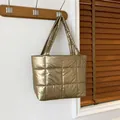Quilted tote bag in metallic gold finish with a spacious padded shoulder strap - Gold