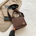 Mini brown corduroy crossbody bag with wide woven strap and adjustable gold buckle - Brown