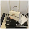Detail of white crossbody bag with woven texture, metal swivel lock and round top handle - Off White