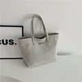 Minimalist grey canvas tote bag with leather handles and metallic plate detail - Silver