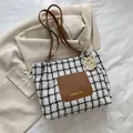 Checkered tote bag with brown leather pocket and a cute yellow cat charm detail - Brown