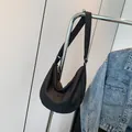 Chic black crescent crossbody bag with quilted texture and adjustable wide strap - Black