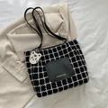 Checkered tweed tote bag with black leather pocket and a cute tiger charm decoration - Black