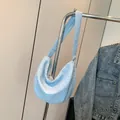 Light blue dumpling bag with bubble texture shown on a metal hanger for summer style - Blue