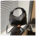 Minimalist black pleated cloud bag with knotted top handle and adjustable shoulder strap - Black