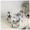 White corduroy tote bag with floral prints and a matching round coin purse on top - Black