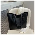 Black leather tote bag with white contrast stitching and large capacity minimalist design - Black