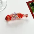 Detail of red flower banana clip with sparkling multi-colored beads and translucent finish - Red