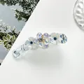 Detail of banana hair clip with blue crystal flowers and iridescent faceted beads - Light Blue