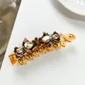 Macro della clip a banana in acetato ambra con fiore di strass e fiocco di cristallo - Oro