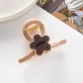 Close-up of 7cm flower hair claw clip with metallic spring and Barrette La France engraving - Dark Brown Flower Decor / Light Pink Amber