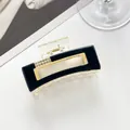 Detail of rectangular hair claw clip with rhinestones and golden metal hardware - Black
