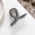 Detail view of small grey hair claw clip featuring sparkling rhinestones and gold spring - Gray
