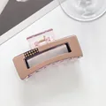 Detail of elegant rectangular hair claw clip with champagne finish and yellow rhinestones - Pink