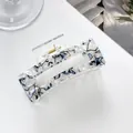 Close-up of a blue and white marble acrylic hair claw clip with a strong gold metal spring - Blue White Marble