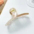 Close-up of extra-large amber and cream tortoiseshell hair claw clip with gold spring - Khaki
