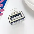 Detail of a rectangular hair claw clip with cream textured stripes and black inner frame - Transparent Cream Black (B)