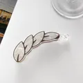 Detail of banana hair clip featuring white marble texture and brown leaf vein patterns - Dark Gray