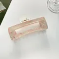 Vista dettagliata di una grande clip per capelli in acetato marmorizzato rosa con molla - Rosa