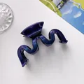 Detail shot of wavy hair claw clip with purple gradient glitter finish and star texture - Dark Blue