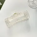 Macro view of extra large square hair claw clip with colorful pearly checkerboard pattern - White