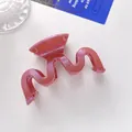 Detailed view of pink glitter wave hair claw clip on a clean minimalist background - Pink