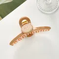 Detail shot of a large 11cm caramel resin hair claw with vintage gold metal spring - Dark Khaki