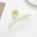 Detail of a large cream claw clip featuring Barrette La France text and a metal spring - Off-white