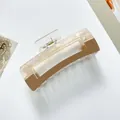 Detail of a minimalist checkered acrylic hair claw clip with beige and brown textures - Large / Khaki