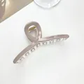 Detail of dusty pink hair claw clip with Barrette La France text and metal spring - Light Khaki