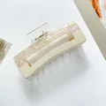 Detail of a rectangular hair claw clip in pearlescent pink and cream white acetate - Large / Off White