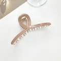 Detail view of pink resin hair claw clip with Barrette La France text on side - Dark Khaki
