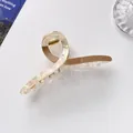 Detail of a large pearlescent and brown acrylic hair claw clip with strong gold metal spring - 11cm / Khaki