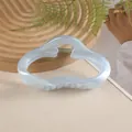 Detail of 11cm cloud-shaped hair claw clip in pearlescent blue on a beige surface - Sky Blue