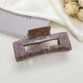 Detail of tortoiseshell patterned rectangular hair claw clip on soft satin background - Dark Brown