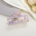 Detailed view of large marble texture acetate hair claw clip with purple floral patterns - Purple Crackle