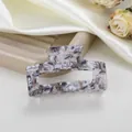 Primer plano de la pinza para el cabello de acetato con textura de mármol gris y negro - Negro de Hielo Agrietado