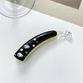 Detail of banana hair clip with colorful rhinestones and clover hollow design on black base - 10cm / Black