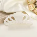 Macro view of cream white marble acetate hair claw with hollow petal design and glossy finish - 10.5cm / Rock White