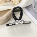 Detail of a black jelly shark clip with heart-shaped rhinestones on elegant fabric - 7cm / Black