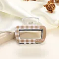 Close-up of a small square checkerboard acrylic hair claw with a transparent spring - 6.5cm / Tan