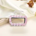 Detail of pink and white checkered acrylic hair claw with metal spring and duck logo - 6.5cm / Pink