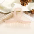 Detail of peach pink translucent hair claw clip with golden spring on elegant tray - 11cm / Flesh Pink