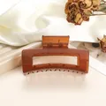 Detail of amber translucent square hair claw clip with metal spring on white silk - 8cm / Watermelon red