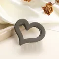 Detailed close-up of a matte dark grey hollow heart hair claw on soft silk fabric - Dark Gray 7cm