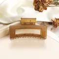 Detail of a brown translucent square hair claw clip on white silk with rose petals - 8cm / Light Camel