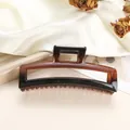 Detail of large rectangular claw clip with tortoiseshell gradient on silk fabric - Amber